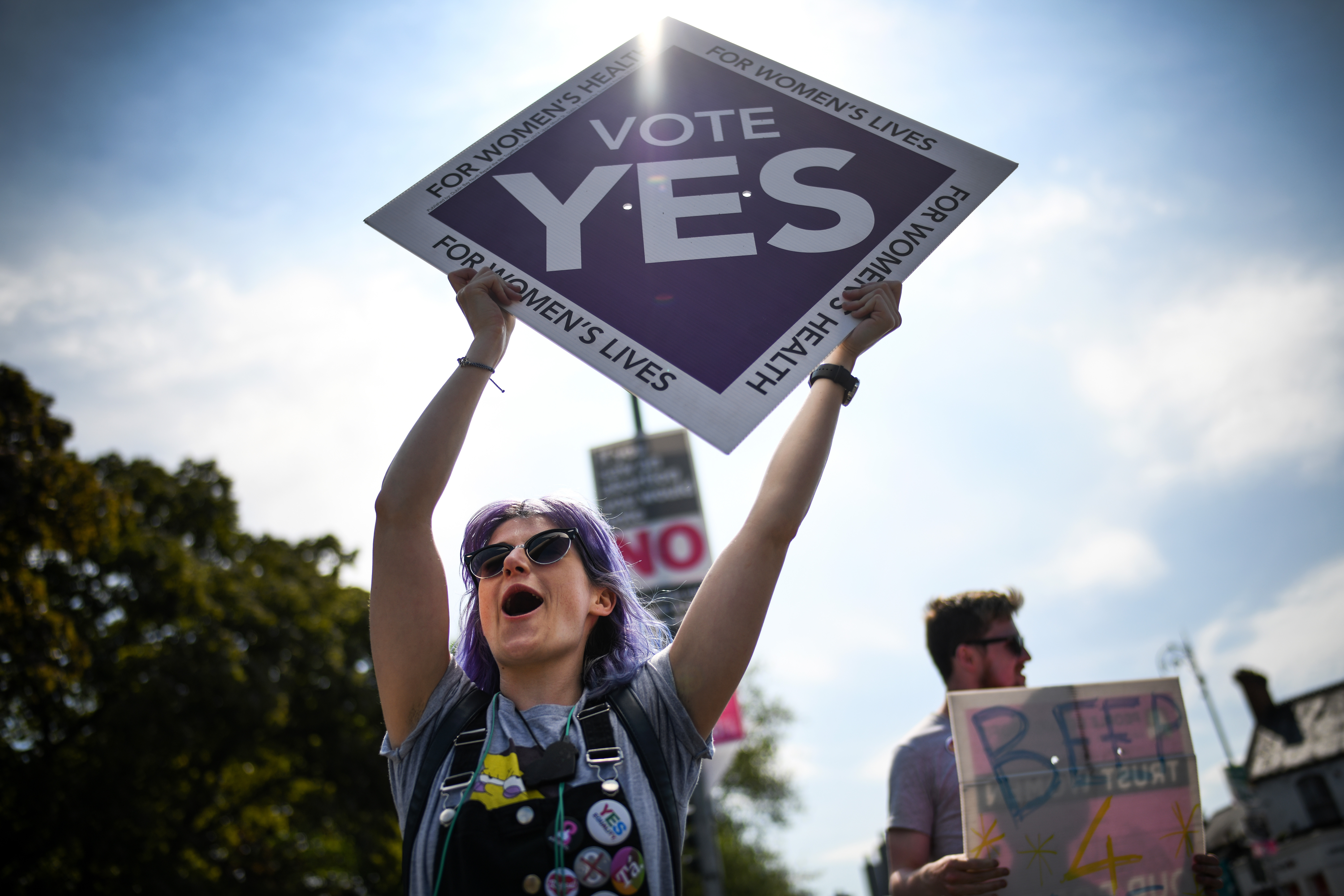 Members of the public hold yes placards on Fairview road as the country heads to  polling stations on May 25, 2018 in Dublin, Ireland.